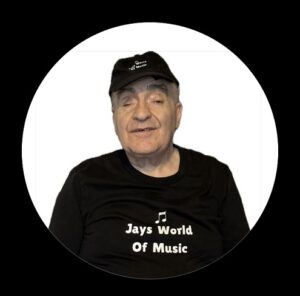 Jay wearing a black T-shirt with "Jays World of Music" printed on